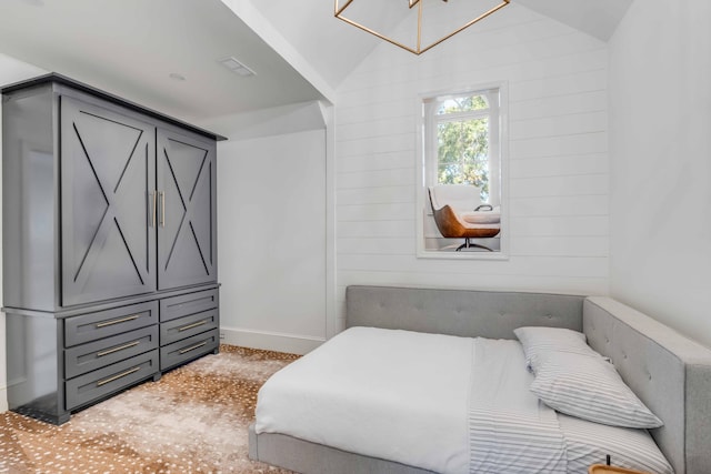 bedroom featuring vaulted ceiling, wood walls, and baseboards