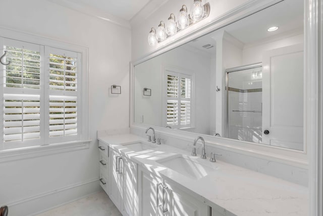 bathroom featuring plenty of natural light, a sink, and a shower stall