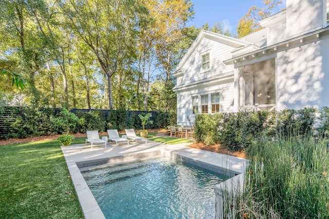 view of pool featuring a patio area, a lawn, fence, and a fenced in pool