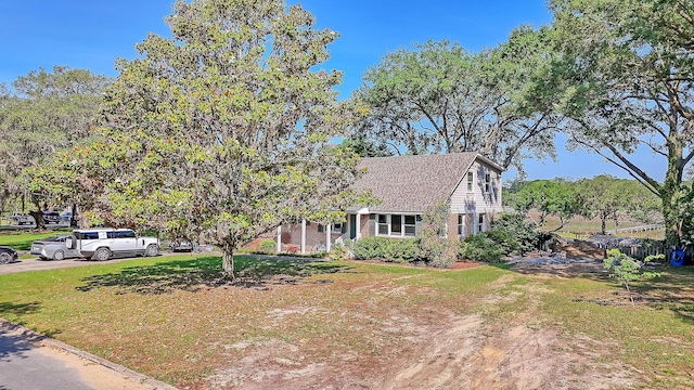 932 N Shem Dr, Mount Pleasant, SC 29464 - view of front of home with brick siding, a front yard, dirt driveway, and a shingled roof