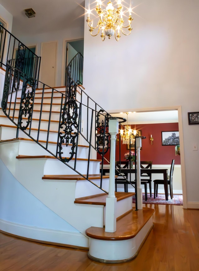 1866 Capri Dr, Charleston, SC 29407 - staircase featuring a chandelier, wood finished floors, and baseboards