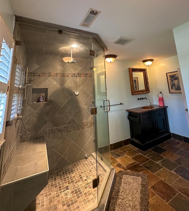 1866 Capri Dr, Charleston, SC 29407 - bathroom with vanity, a stall shower, baseboards, and stone finish floors