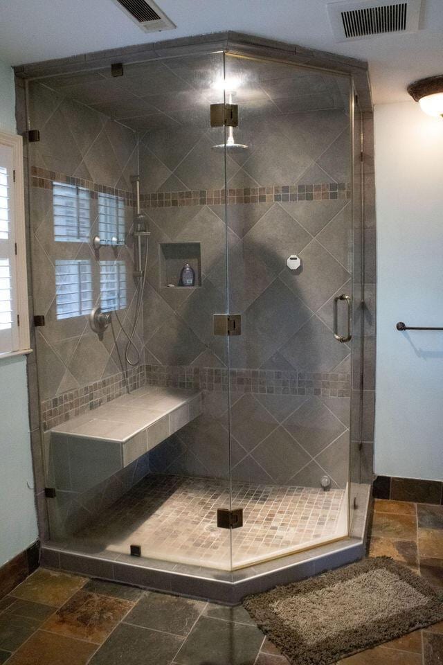 1866 Capri Dr, Charleston, SC 29407 - bathroom featuring stone tile floors, a stall shower, and baseboards