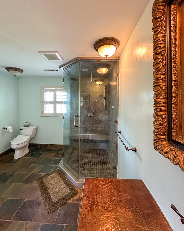 1866 Capri Dr, Charleston, SC 29407 - bathroom featuring toilet, a stall shower, and stone finish flooring