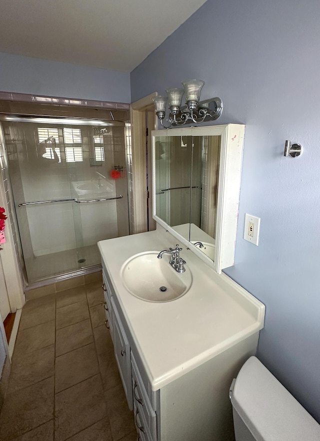 1866 Capri Dr, Charleston, SC 29407 - bathroom featuring vanity, a stall shower, a chandelier, toilet, and tile patterned floors