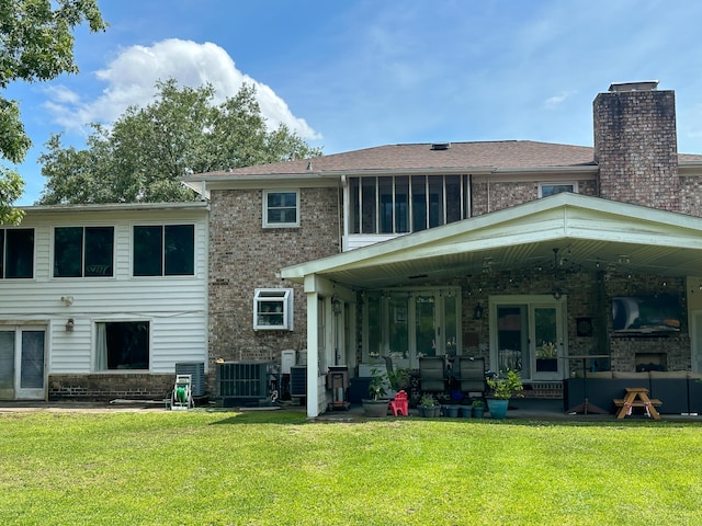 1866 Capri Dr, Charleston, SC 29407 - rear view of house featuring brick siding, a lawn, a fireplace, a patio area, and cooling unit