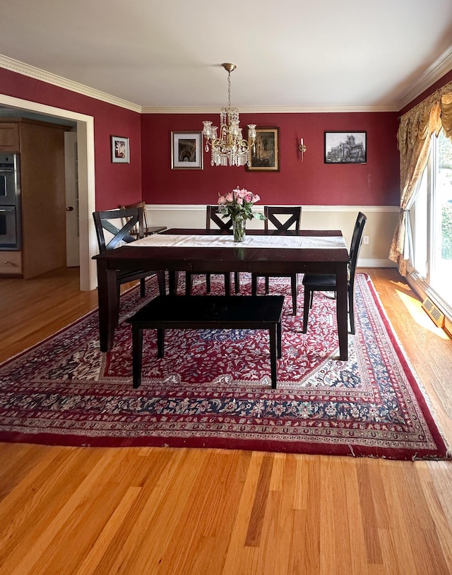 1866 Capri Dr, Charleston, SC 29407 - dining space with a chandelier, light wood-style flooring, crown molding, and baseboards