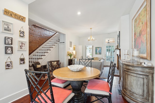 dining area featuring a notable chandelier and dark hardwood / wood-style flooring