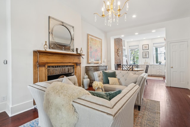 living room featuring dark wood-type flooring and an inviting chandelier