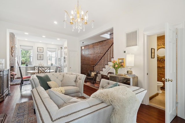 living room featuring dark hardwood / wood-style floors and an inviting chandelier