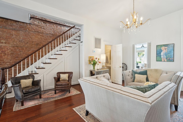 living room with dark wood-type flooring and a notable chandelier