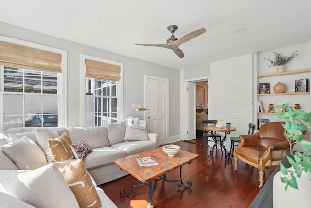 living room with dark hardwood / wood-style floors and ceiling fan