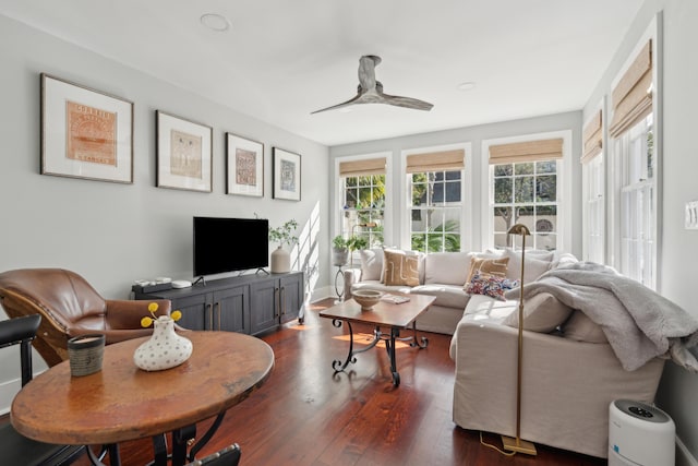 living room featuring ceiling fan and dark wood-type flooring