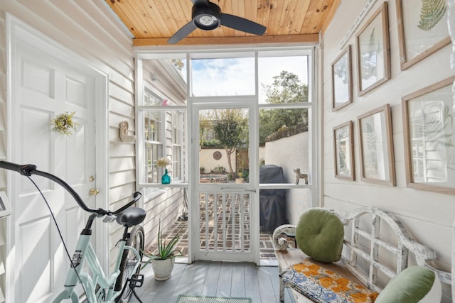 sunroom with ceiling fan and wood ceiling