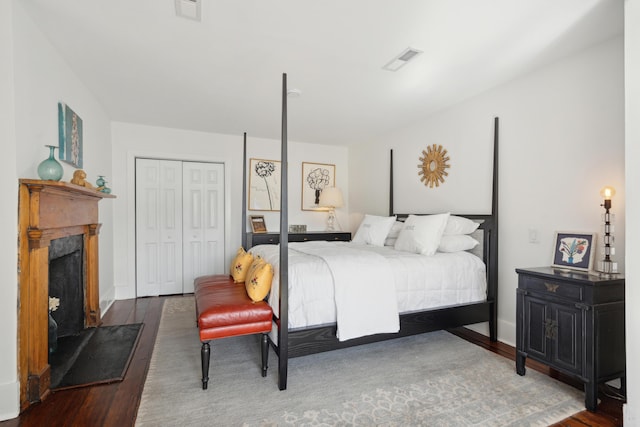 bedroom featuring dark hardwood / wood-style flooring and a closet