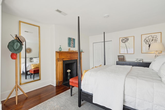 bedroom with a closet and dark wood-type flooring