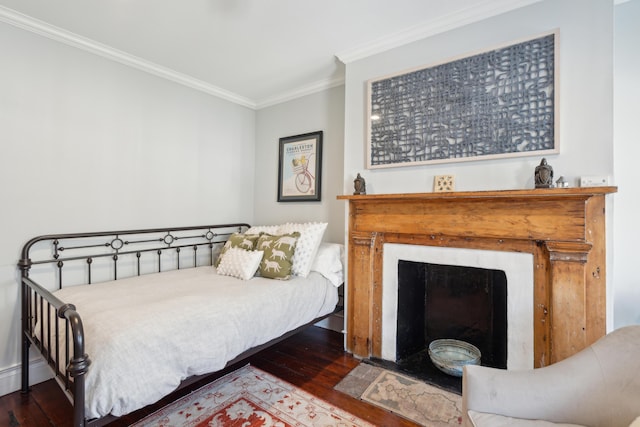 bedroom featuring crown molding and dark wood-type flooring