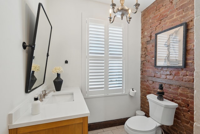 bathroom with tile patterned flooring, vanity, a chandelier, and toilet