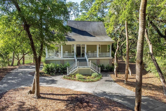 3052 Seabrook Island Rd, Seabrook Island, SC 29455 - view of front of property with a porch, stairway, and roof with shingles