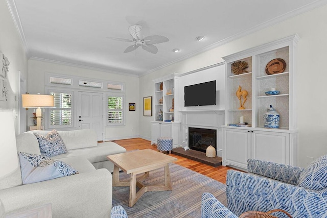 3052 Seabrook Island Rd, Seabrook Island, SC 29455 - living room with light wood-type flooring, ceiling fan, crown molding, a glass covered fireplace, and recessed lighting