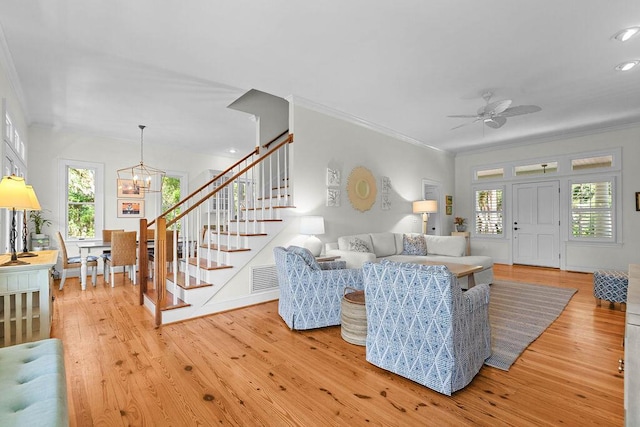 3052 Seabrook Island Rd, Seabrook Island, SC 29455 - living room with ornamental molding, stairway, light wood-style flooring, plenty of natural light, and a chandelier