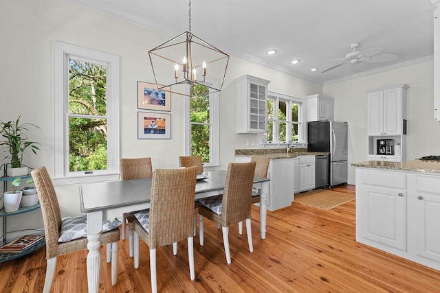 3052 Seabrook Island Rd, Seabrook Island, SC 29455 - dining space with crown molding, light wood finished floors, a chandelier, a ceiling fan, and recessed lighting