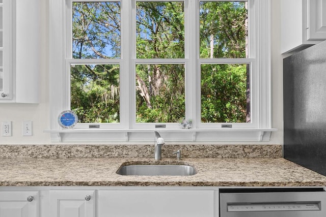 3052 Seabrook Island Rd, Seabrook Island, SC 29455 - kitchen featuring dishwasher, a sink, white cabinets, light stone counters, and black refrigerator