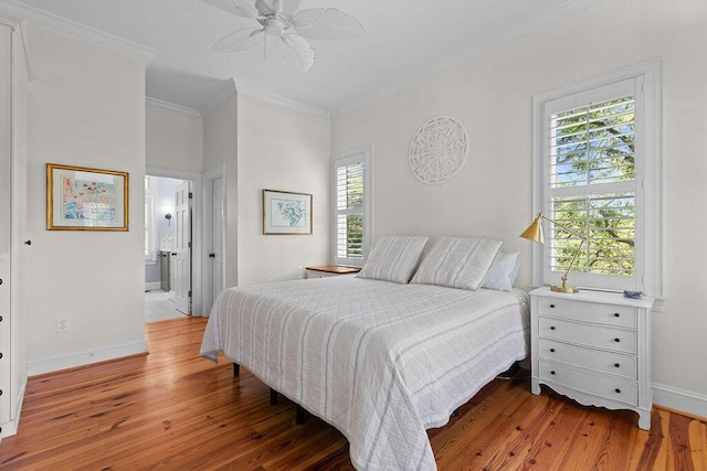 3052 Seabrook Island Rd, Seabrook Island, SC 29455 - bedroom with multiple windows, ornamental molding, wood finished floors, baseboards, and connected bathroom