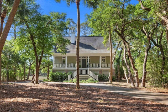 3052 Seabrook Island Rd, Seabrook Island, SC 29455 - coastal inspired home featuring covered porch, stairway, and a chimney
