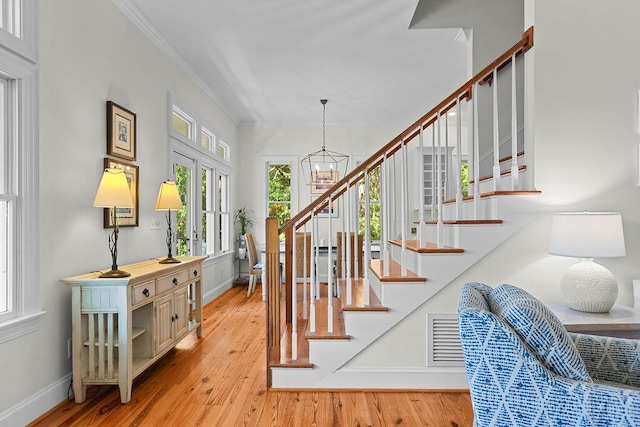 3052 Seabrook Island Rd, Seabrook Island, SC 29455 - stairs with a chandelier, baseboards, wood finished floors, and ornamental molding