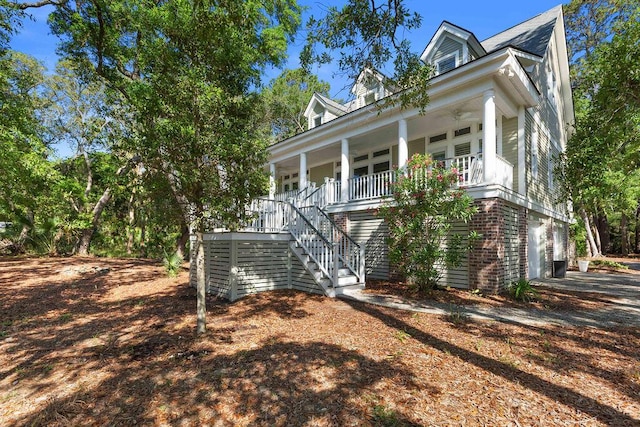 3052 Seabrook Island Rd, Seabrook Island, SC 29455 - view of front facade featuring covered porch, stairway, and an attached garage