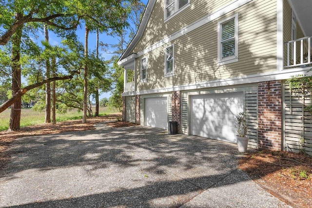 3052 Seabrook Island Rd, Seabrook Island, SC 29455 - view of property exterior featuring an attached garage, driveway, and brick siding
