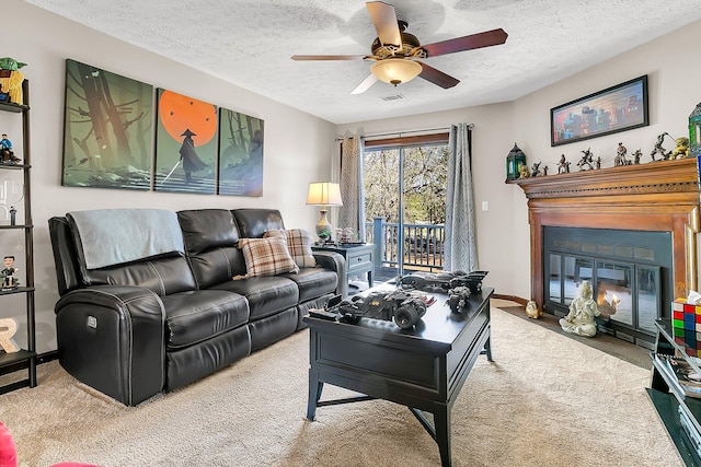 living room with a fireplace with flush hearth, carpet flooring, ceiling fan, a textured ceiling, and baseboards