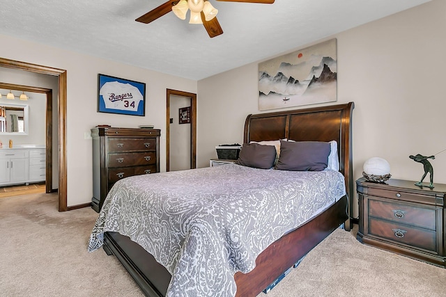 bedroom with light carpet, a textured ceiling, a ceiling fan, and baseboards