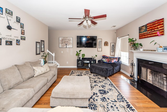 living room featuring ceiling fan and hardwood / wood-style floors