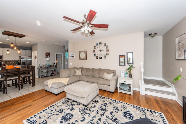 living room with ceiling fan and light wood-type flooring