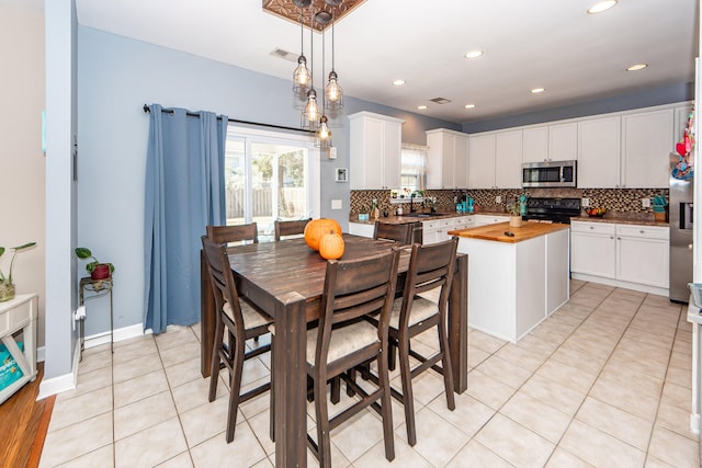 tiled dining space featuring sink