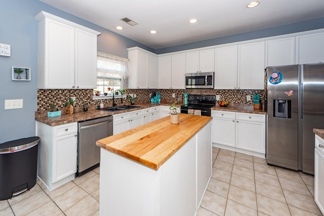 kitchen featuring a center island, appliances with stainless steel finishes, and white cabinets