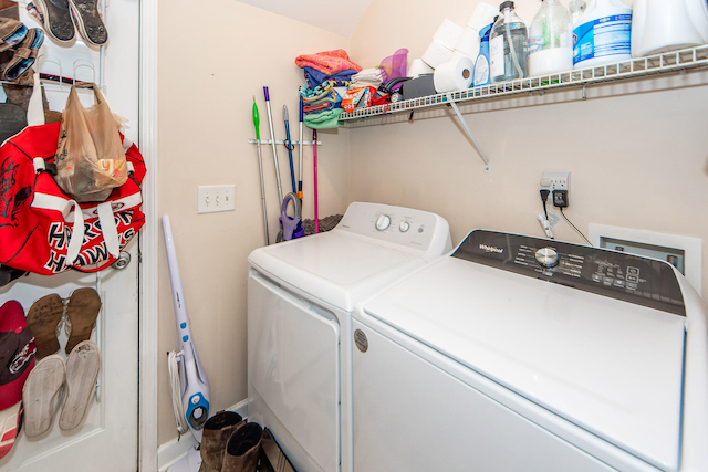 clothes washing area with separate washer and dryer