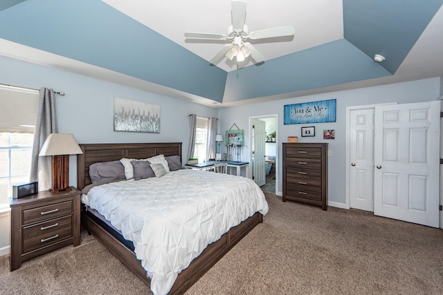 bedroom with ceiling fan, vaulted ceiling, multiple windows, and light colored carpet