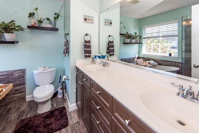 bathroom featuring vanity, toilet, and hardwood / wood-style floors