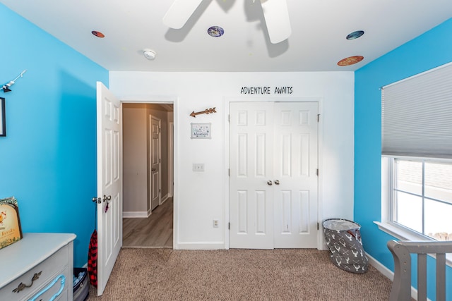 bedroom featuring a closet, ceiling fan, and light colored carpet