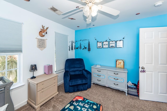 sitting room featuring ceiling fan and light colored carpet