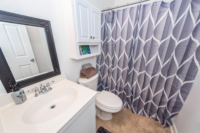 bathroom with vanity, a shower with curtain, toilet, and tile patterned floors