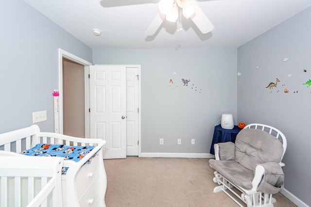 bedroom featuring ceiling fan and light carpet