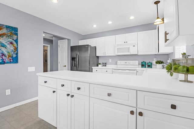 kitchen featuring white cabinets, hanging light fixtures, and white appliances