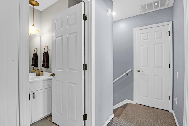 bathroom with tile patterned flooring and vanity