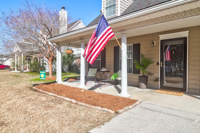 view of exterior entry with covered porch