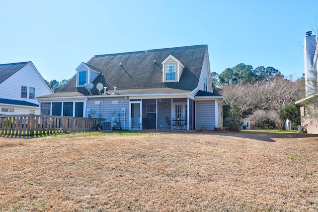 back of property featuring central AC unit and a yard