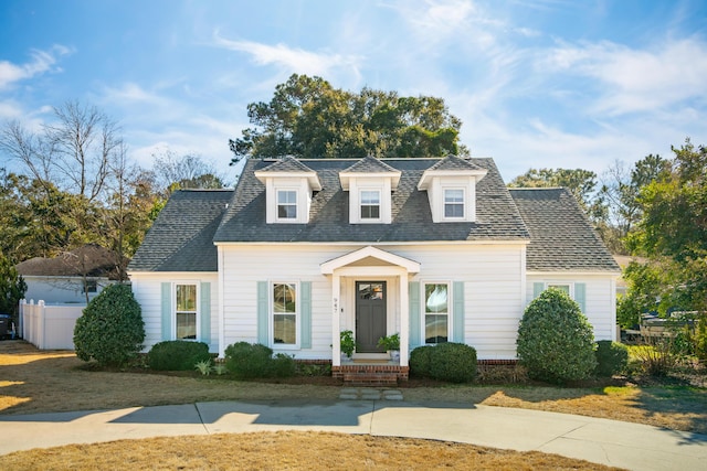 cape cod-style house with a front lawn